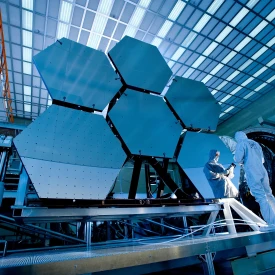 person checking solar panels used for satellite